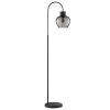 Brilliant lampa podłogowa Ligari, wygięte ramię, przydymiony klosz kroplowy, obok sofy